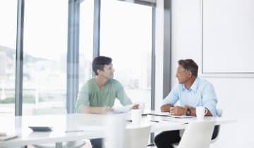 Two business men talking to each other