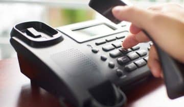 hand with landline phone